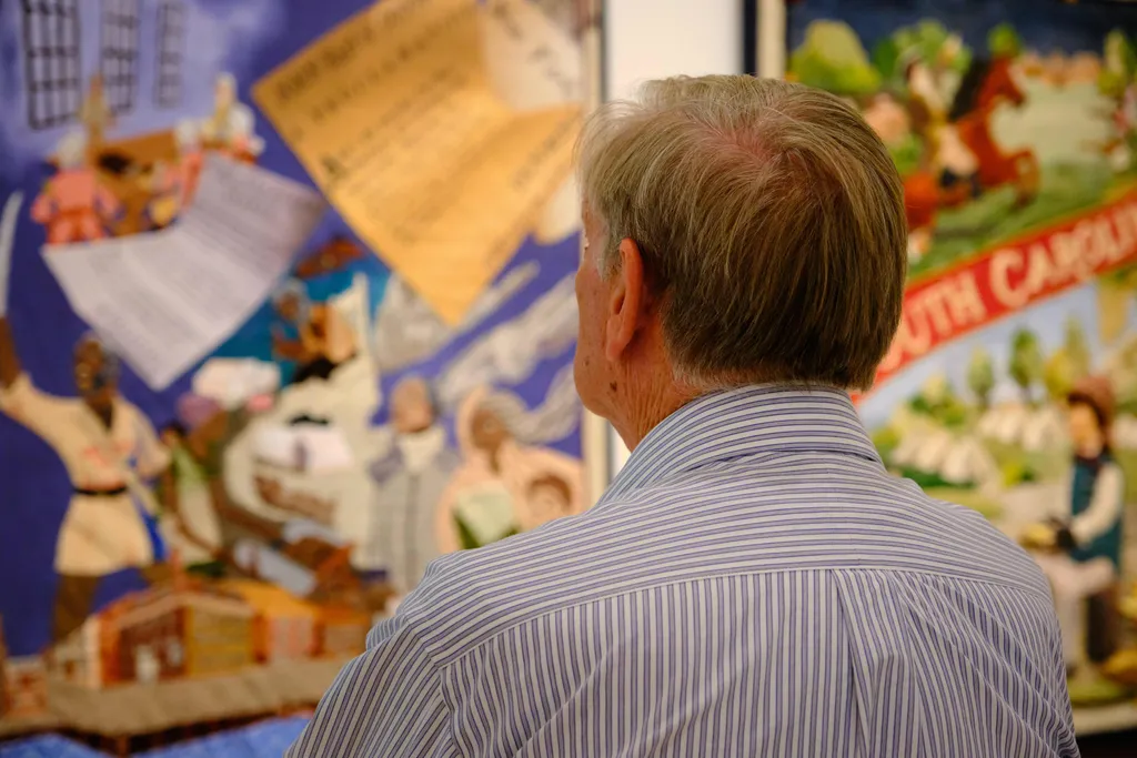 A visitor studies the South Carolina panel