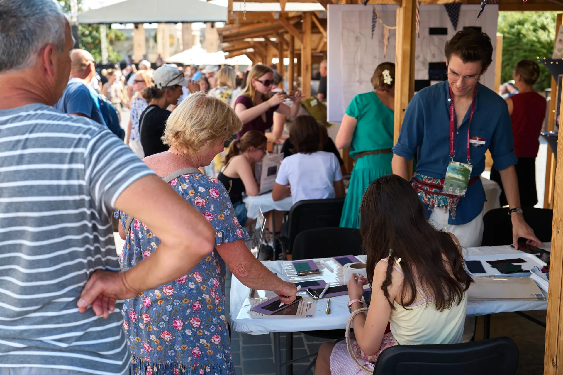 Visitors gather at the America's Tapestry table