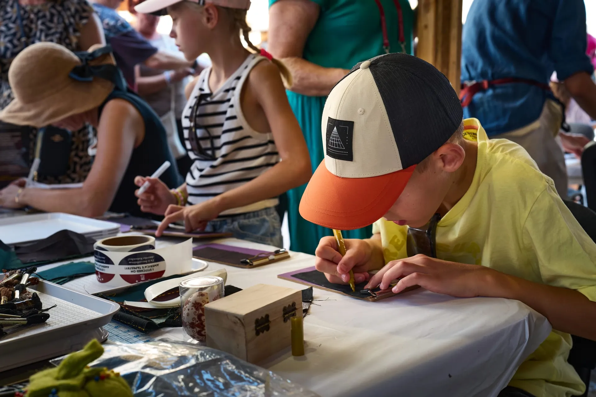 A young visitor tries his hand at the fabric squares