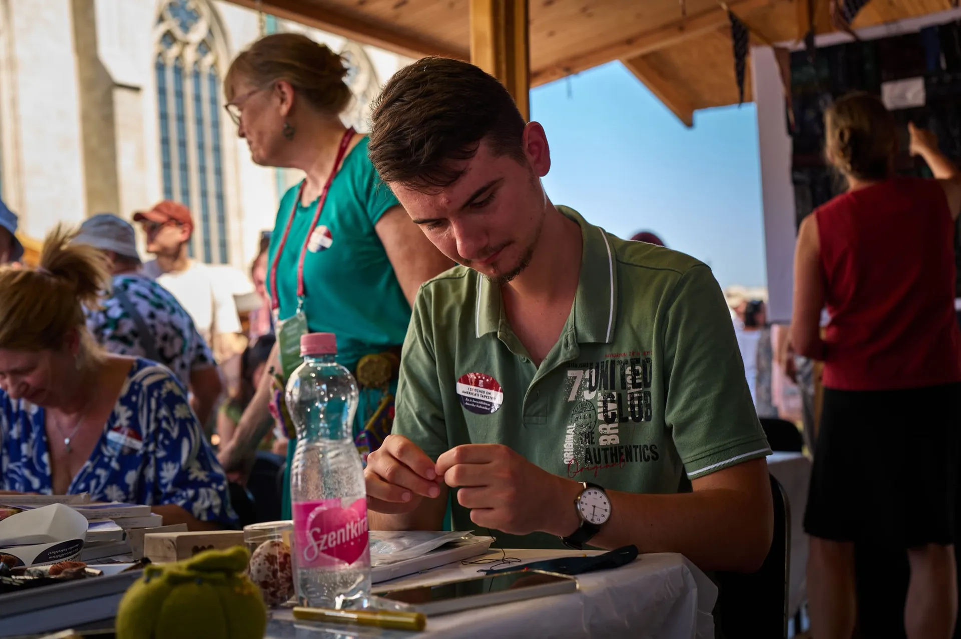 A young visitor at work on a fabric square
