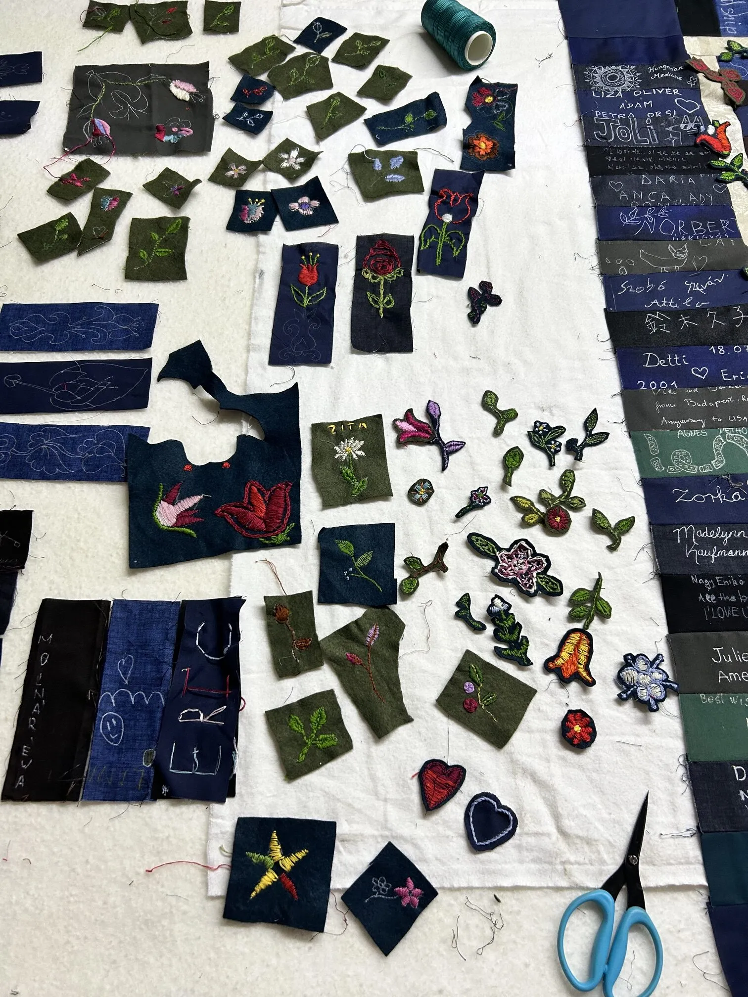 Appliqué flowers and leaves cut out and laid ready on the work table